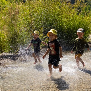 Children enjoying water play in the Bush Creek/Arrow River on Arrowtown's outskirts